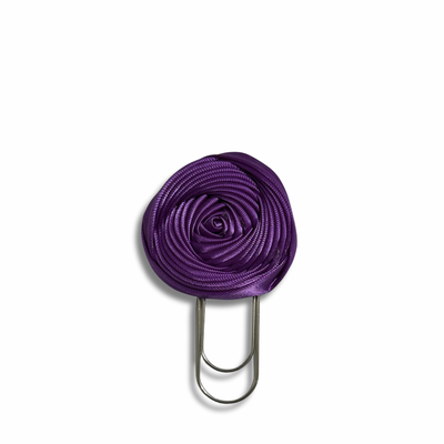 Purple flower-shaped clip on a white background