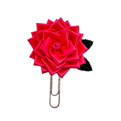 Red rose-shaped clip on a white background
