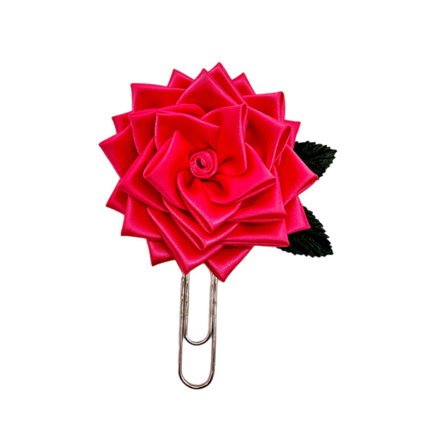 Red rose-shaped clip on a white background