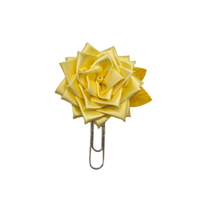 Yellow rose-shaped clip on a white background