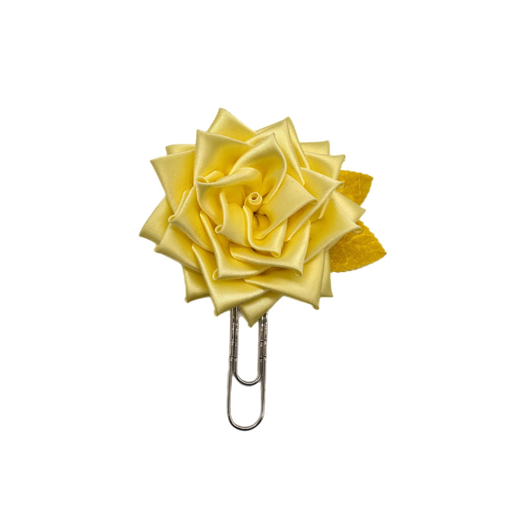 Yellow rose-shaped clip on a white background
