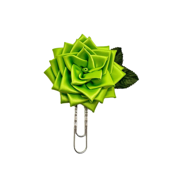 Green flower-shaped clip on a white background
