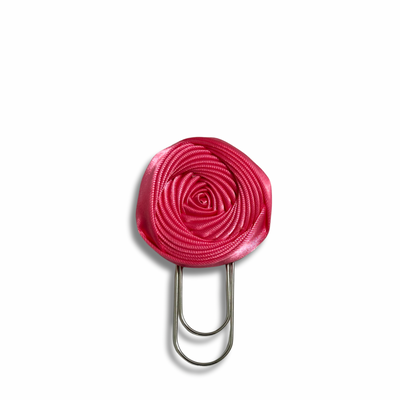 Pink rose-shaped clip on a white background