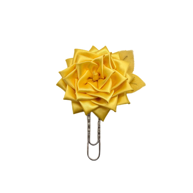 Yellow flower-shaped clip on a white background